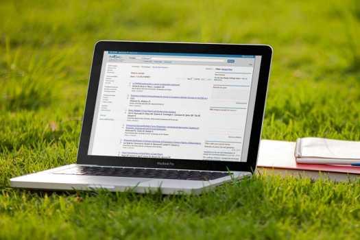 Laptop and books on a lawn