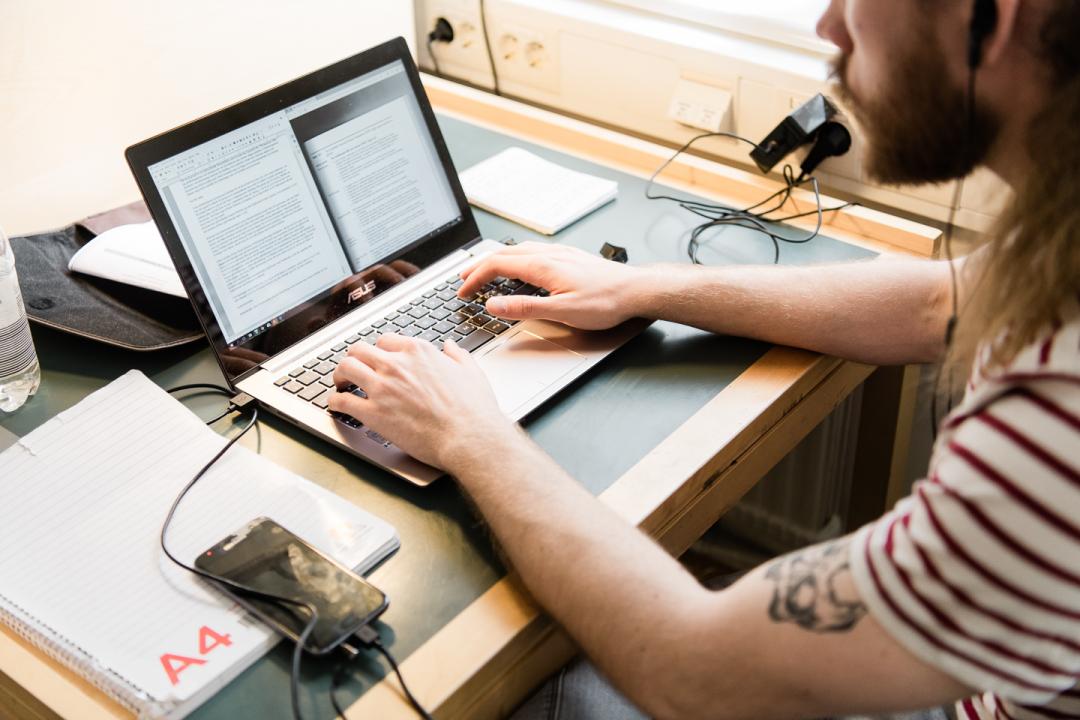 A person is working in front of a computer.